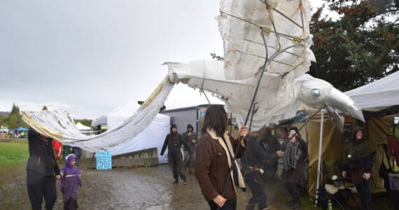 Sea Legs Stilt and Puppet Troupe parades down Pirate Alley with a raven puppet, boasting a 15-foot wingspan, at Ye Olde Harvest Festival at Karen Hornaday Park on Saturday, Oct. 5, 2024, in Homer, Alaska. (Delcenia Cosman/Homer News)