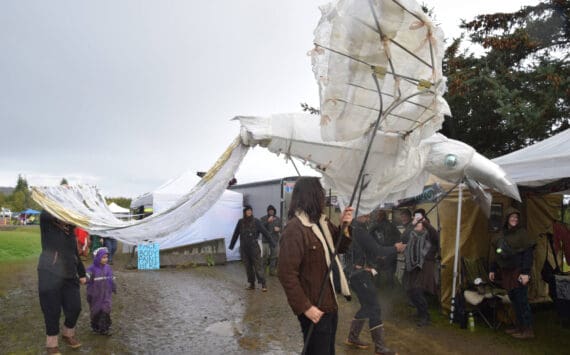 Sea Legs Stilt and Puppet Troupe parades down Pirate Alley with a raven puppet, boasting a 15-foot wingspan, at Ye Olde Harvest Festival at Karen Hornaday Park on Saturday, Oct. 5, 2024, in Homer, Alaska. (Delcenia Cosman/Homer News)