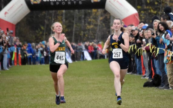 Seward’s Juniper Ingalls and Homer’s Beatrix McDonough sprint to the finish in the Division II girls race at the state cross-country running meet on Saturday, Oct. 5, 2024, at Bartlett High School in Anchorage, Alaska. (Photo by Jeff Helminiak/Peninsula Clarion)