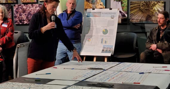 Agnew::Beck project consultant Shelly Wade explains the public feedback process at the Comprehensive Plan Open House on Thursday, March 28, 2024 at the Alaska Maritime National Wildlife Refuge Visitor Center auditorium in Homer, Alaska. (Delcenia Cosman/Homer News)