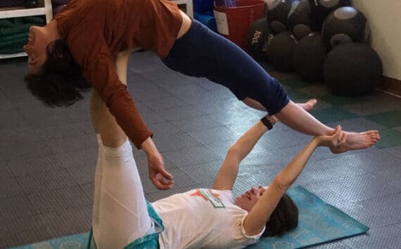 Joolee Aurand, on bottom, demonstrates a yoga pose in this undated photo taken in Homer, Alaska. (Photo provided)