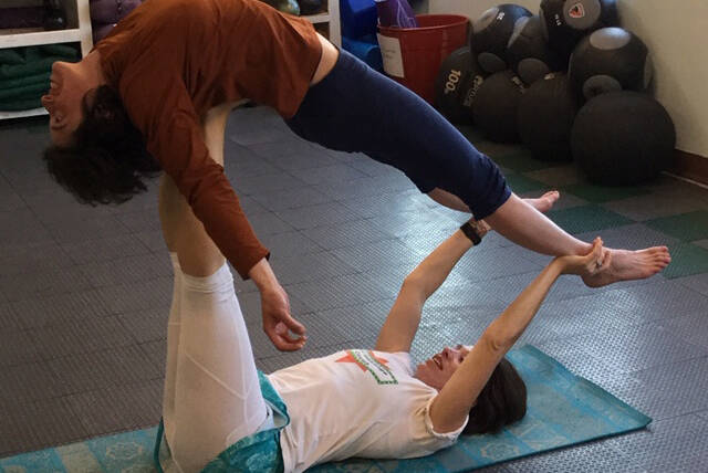 Joolee Aurand, on bottom, demonstrates a yoga pose in this undated photo taken in Homer, Alaska. (Photo provided)