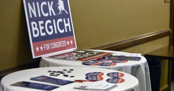 Nick Begich III campaign materials sit on tables ahead of a May 16, 2022, GOP debate held in Juneau. (Peter Segall / Juneau Empire file photo)