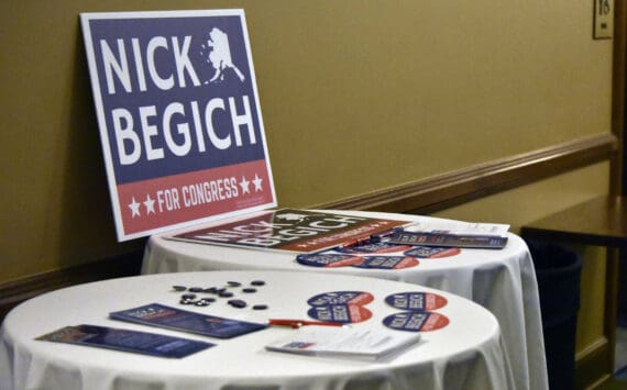 Nick Begich III campaign materials sit on tables ahead of a May 16, 2022, GOP debate held in Juneau. (Peter Segall / Juneau Empire file photo)