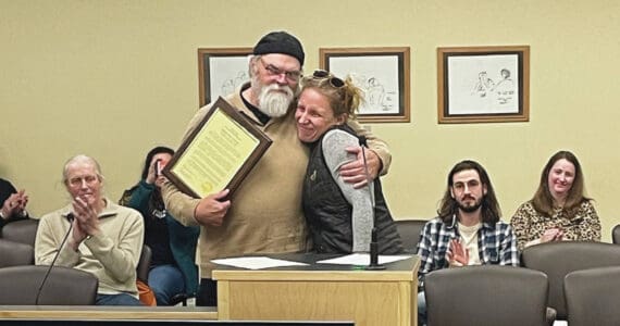 Homer’s new mayor, Rachel Lord, presents outgoing Mayor Ken Castner with a plaque recognizing his service to the City of Homer at the conclusion of the city council meeting at the Cowles Council Chambers at Homer City Hall on Oct. 14, 2024, in Homer, Alaska. (Emilie Springer/Homer News)