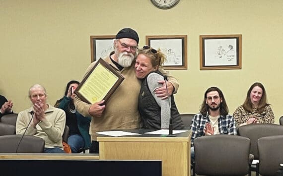 Homer’s new mayor, Rachel Lord, presents outgoing Mayor Ken Castner with a plaque recognizing his service to the City of Homer at the conclusion of the city council meeting at the Cowles Council Chambers at Homer City Hall on Oct. 14, 2024, in Homer, Alaska. (Emilie Springer/Homer News)