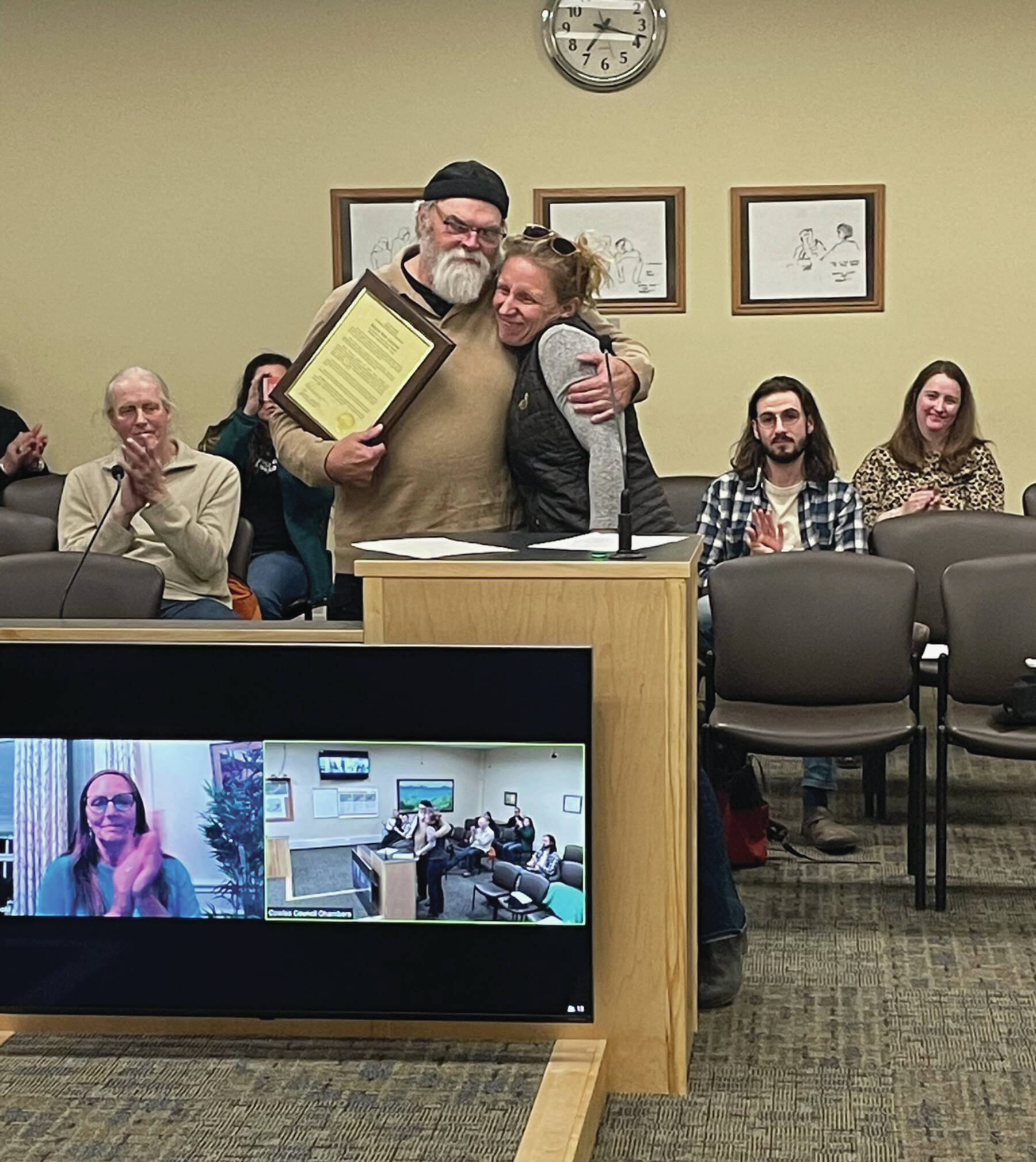 Homer’s new mayor Rachel Lord presents Ken Castner with a plaque recognizing his service to the city of Homer at the conclusion of the City Council meeting at the Cowles Council Chambers at Homer City Hall on Oct. 14, 2024. Emilie Springer/ Homer News