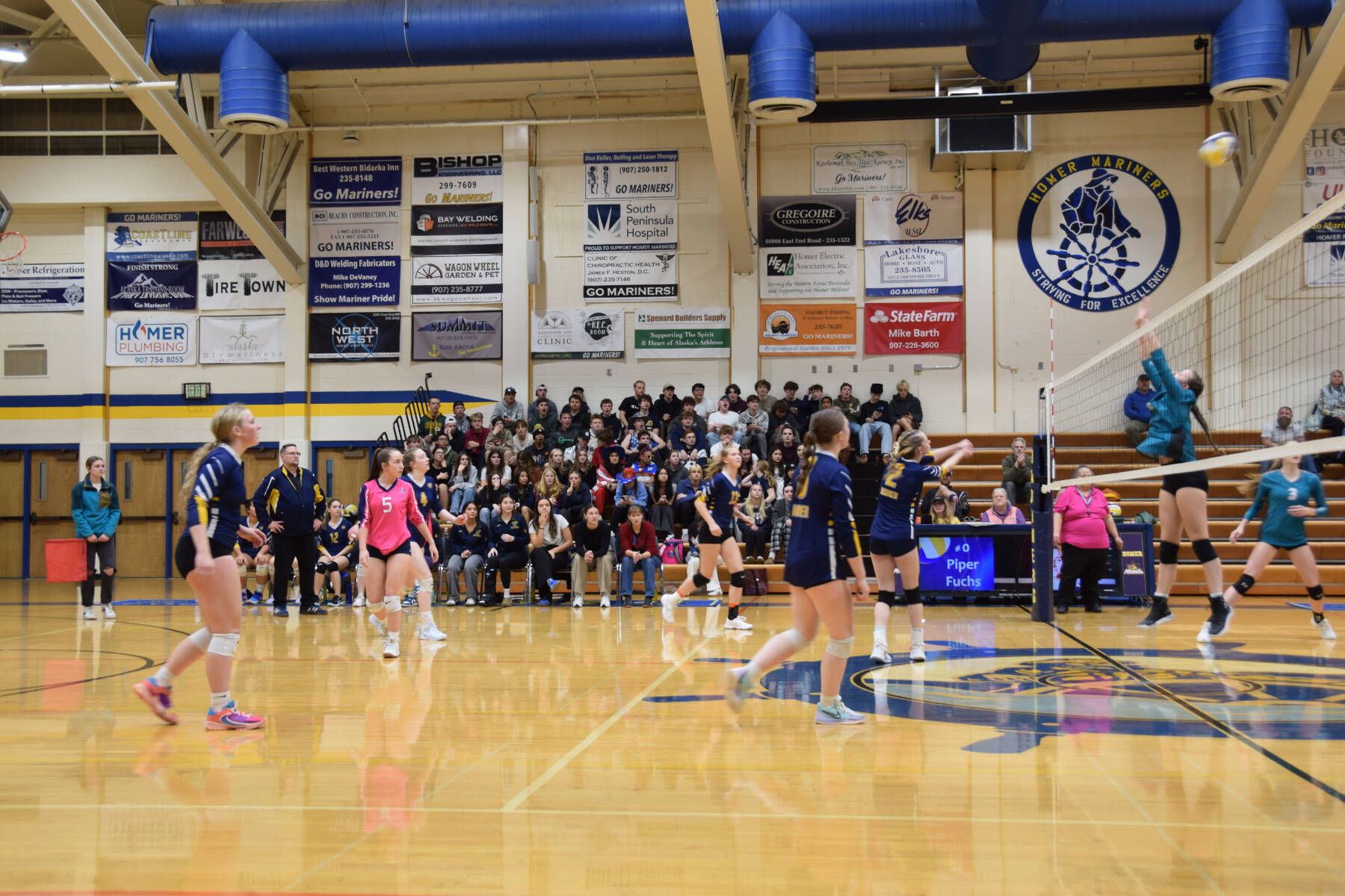 Brightly Thoning bumps the ball over the net during the varsity volleyball game against Nikiski on Thursday, Oct. 17, 2024, in the Homer High School Alice Witte Gymnasium in Homer, Alaska. (Emilie Springer/Homer News)