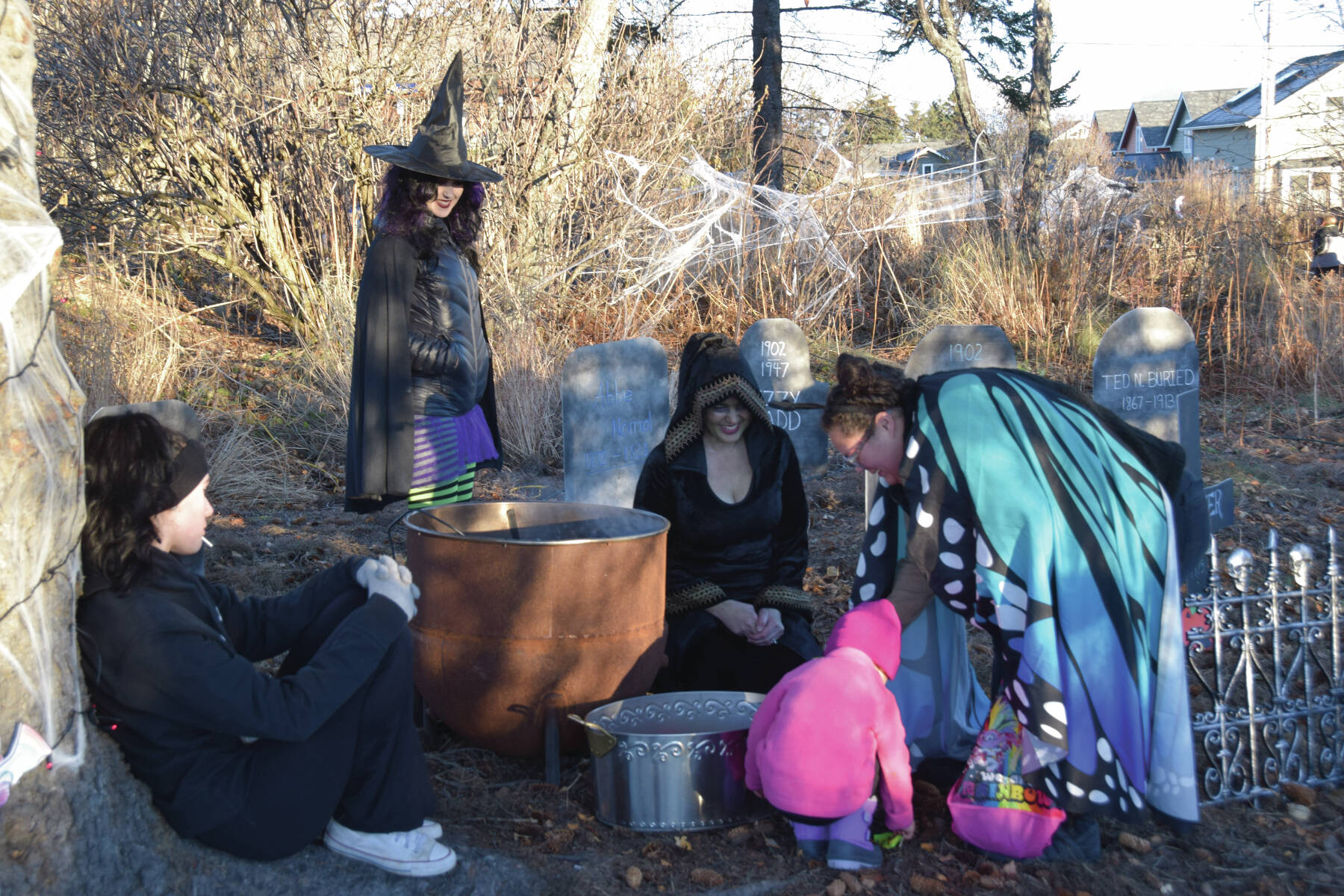 Community members collect candy from a witch’s cauldron in the Haunted Trail during the third annual Fall Fest on Saturday, Oct. 26<ins>, 2024,</ins> at the Homer Chamber of Commerce and Visitor Center<ins> in Homer, Alaska</ins>. (Delcenia Cosman/Homer News)