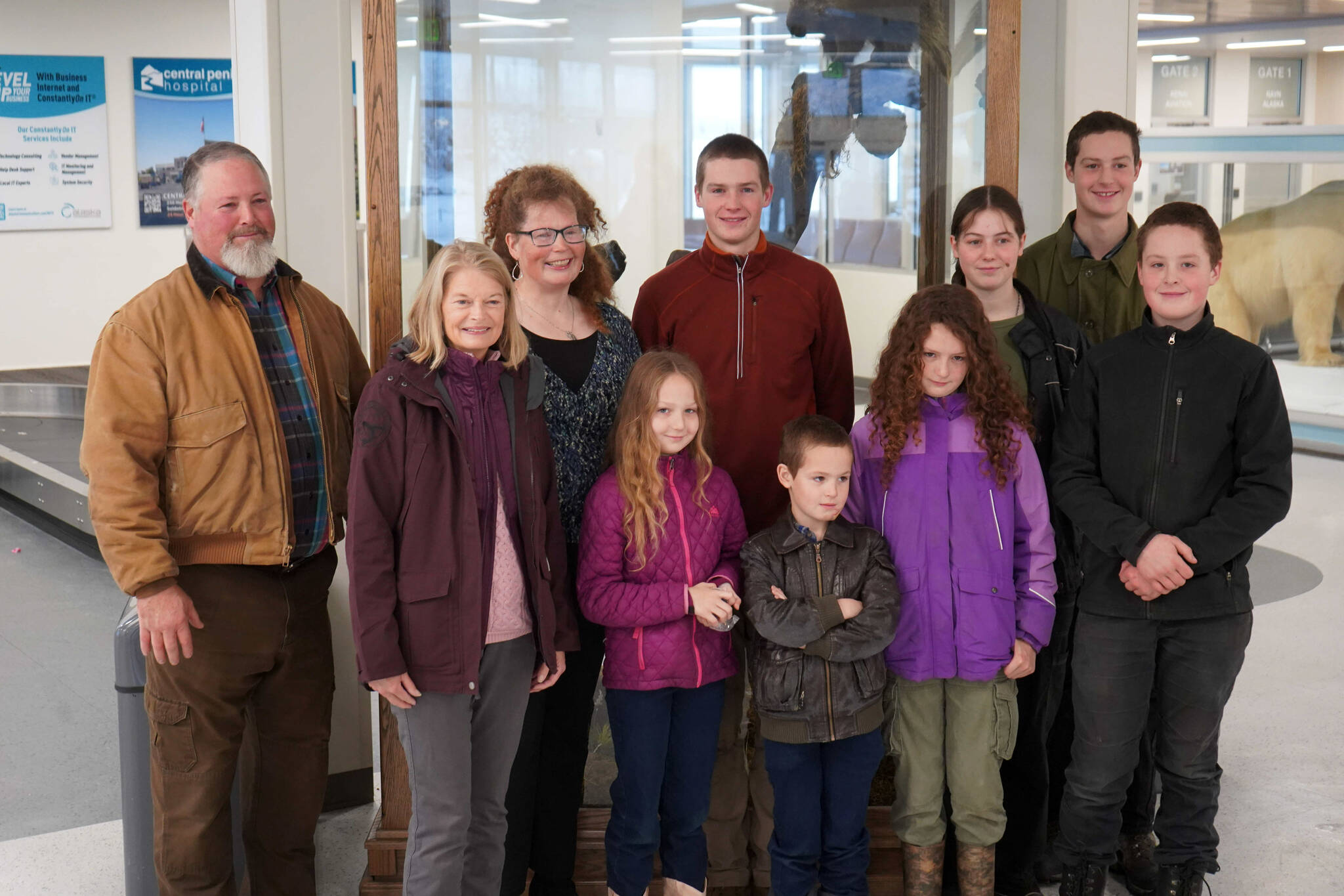 Sen. Lisa Murkowski, second from left, stands for a photo with the Burke family at the Kenai Municipal Airport in Kenai, Alaska, on Friday, Nov. 1, 2024. (Jake Dye/Peninsula Clarion)