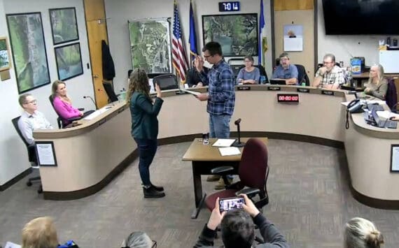 Seward City Clerk Kris Peck, right, administers an oath of office to Seward City Council newcomer Casie Warner during a council meeting in Seward, Alaska, on Oct. 28, 2024. (Screenshot courtesy City of Seward)