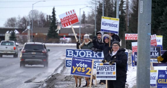 Signs and supporters line the Kenai Spur Highway in Kenai, Alaska, on Tuesday, Nov. 5, 2024. (Jake Dye/Peninsula Clarion)