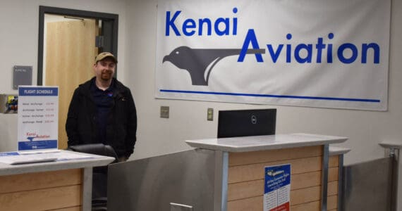 Jacob Caldwell, chief executive officer of Kenai Aviation, stands at the Kenai Aviation desk at the Kenai Municipal Airport on Thursday, Sept. 13, 2022, in Kenai, Alaska. (Jake Dye/Peninsula Clarion)