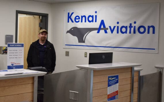 Jacob Caldwell, chief executive officer of Kenai Aviation, stands at the Kenai Aviation desk at the Kenai Municipal Airport on Thursday, Sept. 13, 2022, in Kenai, Alaska. (Jake Dye/Peninsula Clarion)