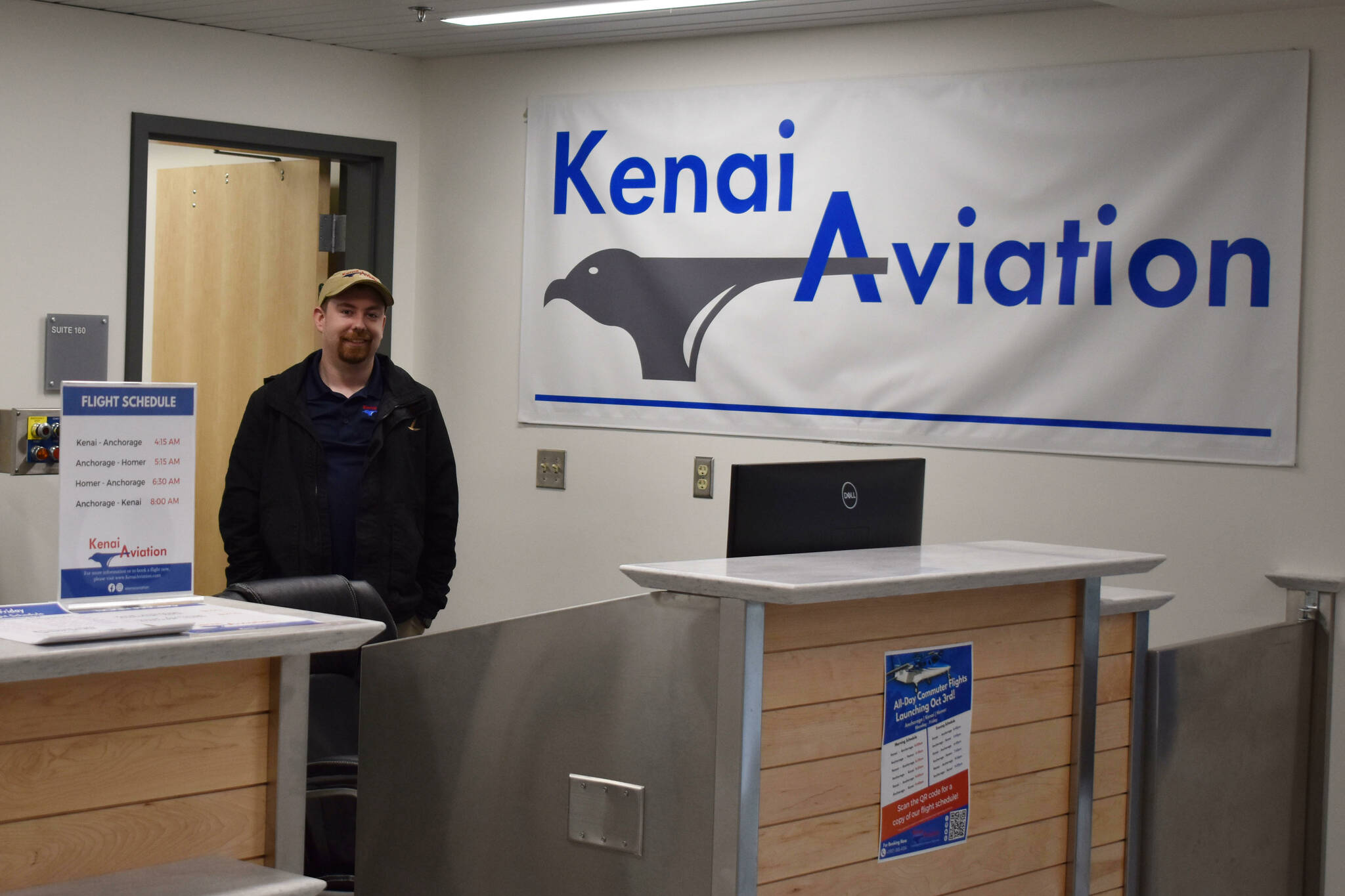 Jacob Caldwell, chief executive officer of Kenai Aviation, stands at the Kenai Aviation desk at the Kenai Municipal Airport on Thursday, Sept. 13, 2022, in Kenai, Alaska. (Jake Dye/Peninsula Clarion)