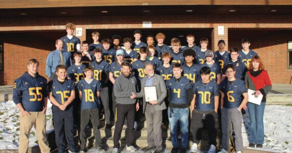 Photo by Leland Curtis
The Homer High School varsity football team, athletic director and head coach Justin Zank and principal Doug Waclawski are photographed with Kenai Peninsula Borough Mayor Peter Micciche and KPB Assembly member Kelly Cooper during an award presentation on Thursday, Nov. 21 at Homer High School.