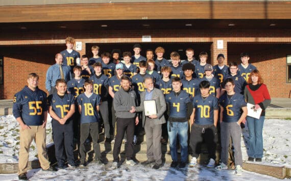 Photo by Leland Curtis
The Homer High School varsity football team, athletic director and head coach Justin Zank and principal Doug Waclawski are photographed with Kenai Peninsula Borough Mayor Peter Micciche and KPB Assembly member Kelly Cooper during an award presentation on Thursday, Nov. 21 at Homer High School.