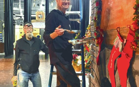 Michael McKinney and Bobby McKinney add finishing touches to the party scene fireplace at the Homer “Nutcracker” rehearsals on Sunday at the Homer Mariner Theater. (Emilie Springer/ Homer News)