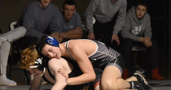 Nikiski’s Mason Doth works his way to a pin of Kenai Central’s Leighton Wilshusen on Tuesday, Nov. 26, 2024, at Nikiski Middle-High School in Nikiski, Alaska. (Photo by Jeff Helminiak/Peninsula Clarion)