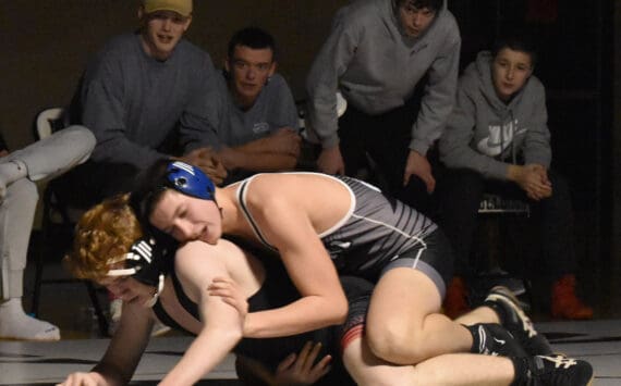 Nikiski’s Mason Doth works his way to a pin of Kenai Central’s Leighton Wilshusen on Tuesday, Nov. 26, 2024, at Nikiski Middle-High School in Nikiski, Alaska. (Photo by Jeff Helminiak/Peninsula Clarion)