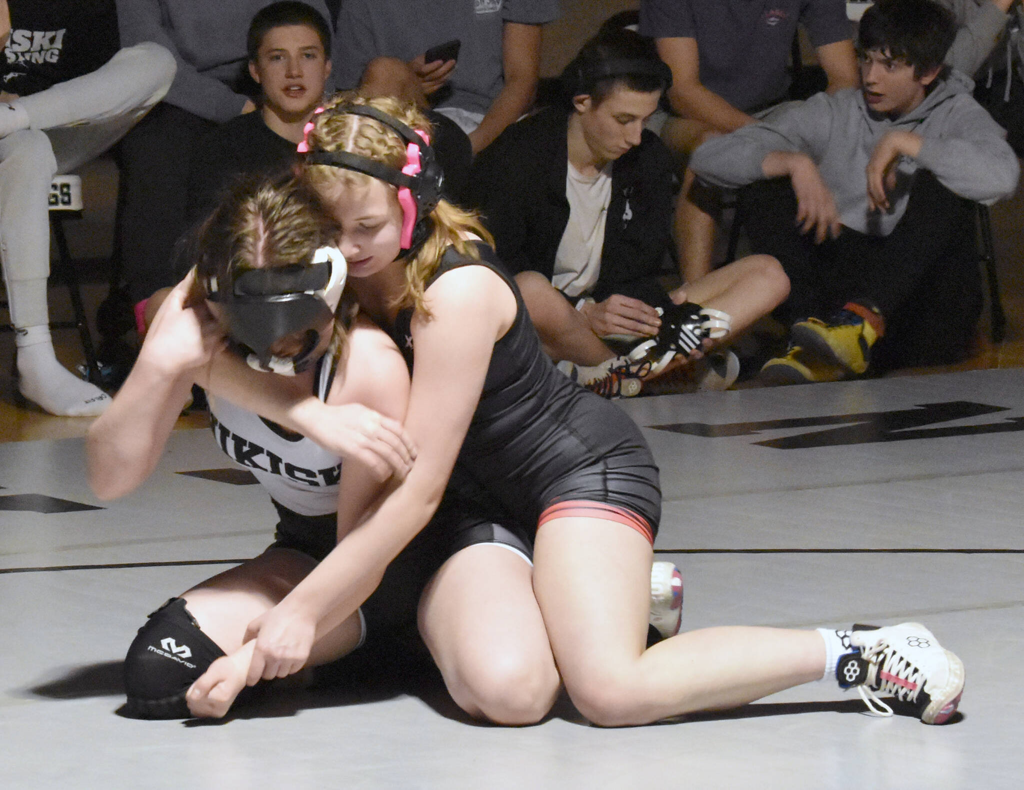 Kenai Central’s Rylee Kent works her way to a pin of Nikiski’s Addison Perkins on Tuesday, Nov. 26, 2024, at Nikiski Middle-High School in Nikiski, Alaska. (Photo by Jeff Helminiak/Peninsula Clarion)