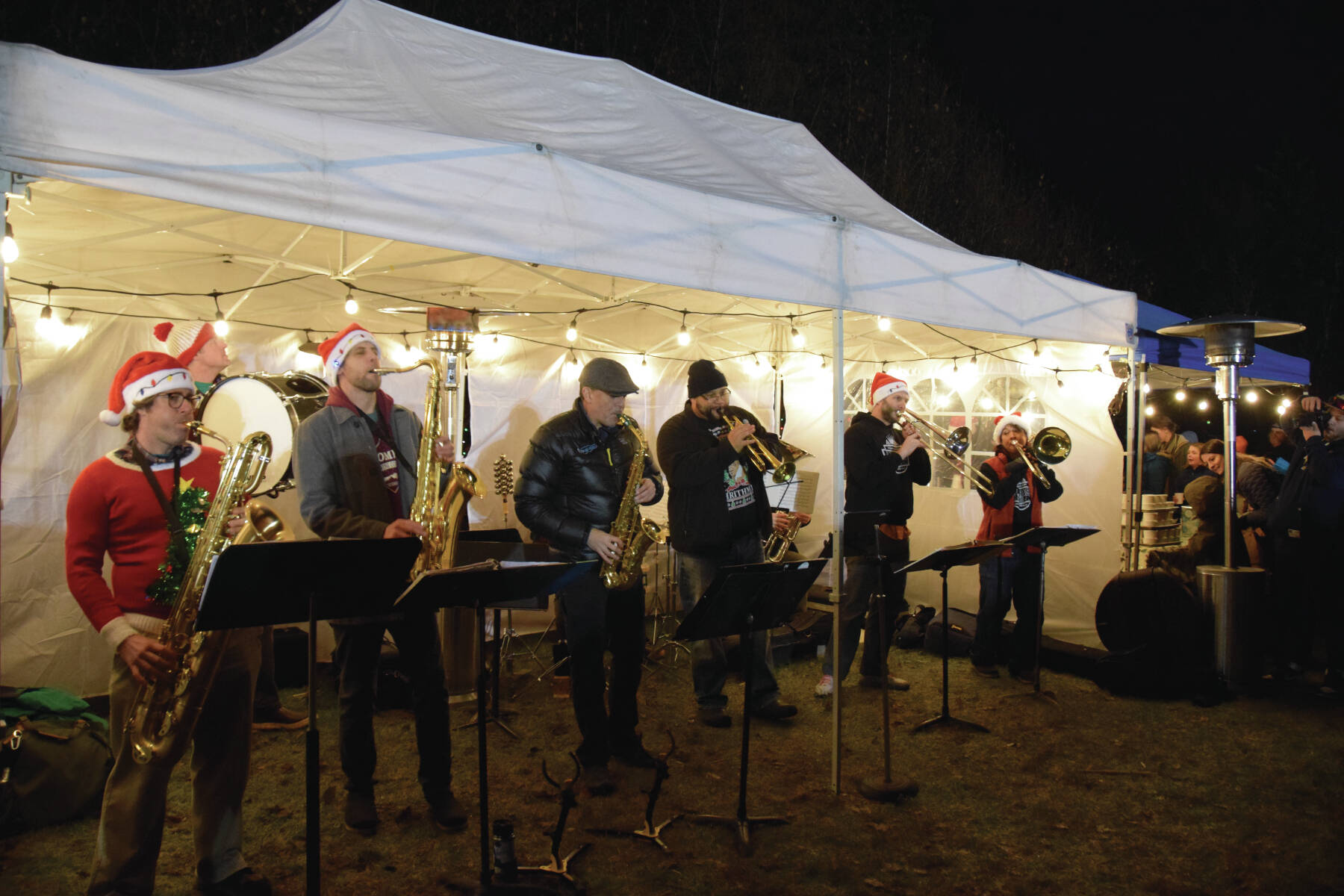 The KP Brass Band plays “Jingle Bells” and other holiday and classic favorites during the Homer Chamber of Commerce’s annual Christmas tree lighting on Thursday, Dec. 5,<ins> 2024, in Homer, Alaska</ins> with the KP Brass Band providing live music. The celebration also brought Santa Claus, escorted by the Homer Volunteer Fire Department, to visit with children in attendance. Chamber board members and volunteers handed out hot cocoa, cider and s’mores to community members, while inside the chamber building parents helped their kids craft holiday ornaments. (Delcenia Cosman/Homer News)