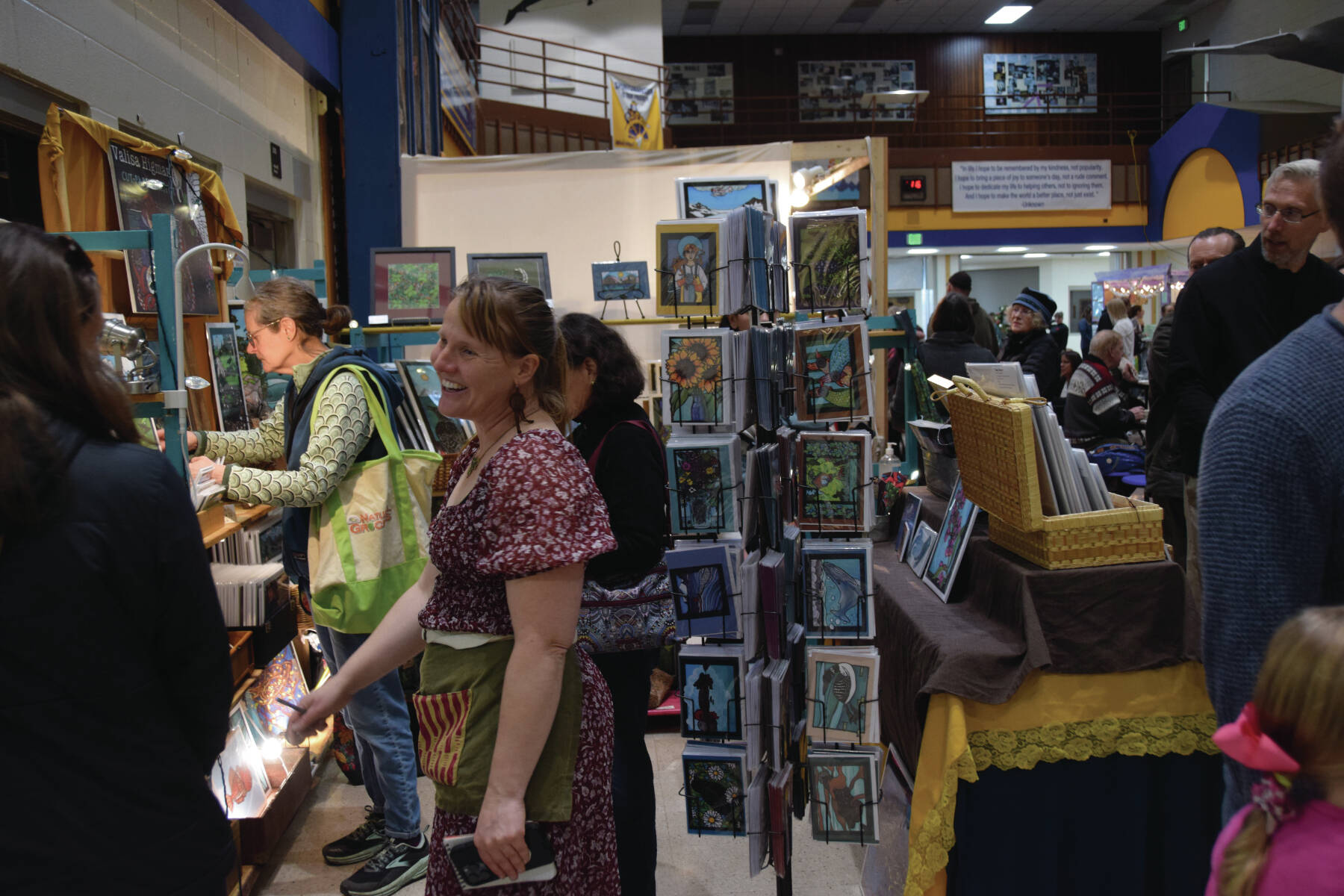 Seldovia artist Valisa Higman talks with customers at her booth during Homer Council on the Arts’ annual Nutcracker Faire on Saturday, Dec. 7<ins>, 2024, in Homer, Alaska</ins>. Dozens of vendors booths and hundreds of people filled the Homer High School commons and gym during the annual event, which coincided with the opening weekend of Homer’s traditional “Nutcracker” ballet. (Delcenia Cosman/Homer News)