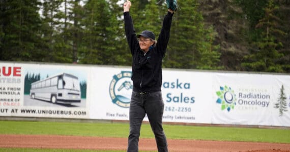 Lisa Parker, vice mayor of Soldotna, celebrates after throwing the ceremonial first pitch before a game between the Peninsula Oilers and the Mat-Su Miners on Tuesday, July 4, 2023, at Coral Seymour Memorial Park in Kenai, Alaska. (Jake Dye/Peninsula Clarion)