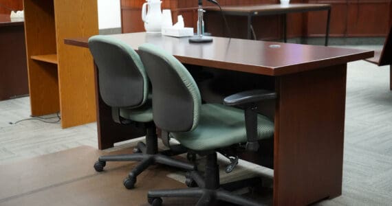 A table used by parties to a case sits empty in Courtroom 4 of the Kenai Courthouse in Kenai, Alaska, on Wednesday, Dec. 11, 2024. (Jake Dye/Peninsula Clarion)