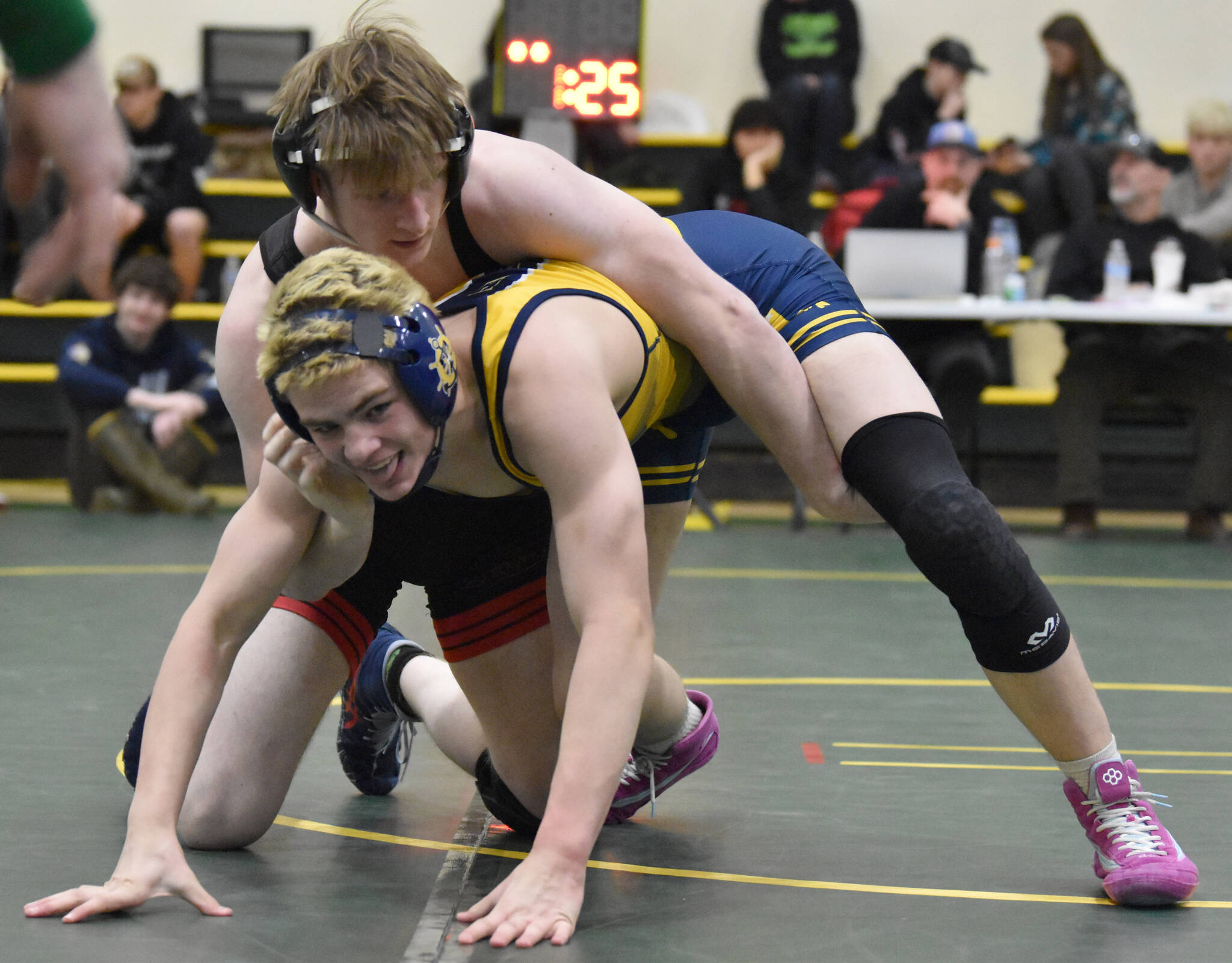 Kenai Central’s Thaddeus Lingenfelter wrestles to a victory over Homer’s Isaiah Mann in the championship match at 189 pounds at the Kachemak Conference wrestling tournament at Seward High School in Seward, Alaska, on Saturday, Dec. 14, 2024. (Photo by Jeff Helminiak/Peninsula Clarion)