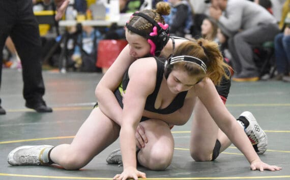 Kenai Central’s Rylee Trent wrestles to a victory over Redington’s Alejandra Roman in the championship match at 138 pounds at the Kachemak Conference wrestling tournament at Seward High School in Seward, Alaska, on Saturday, Dec. 14, 2024. (Photo by Jeff Helminiak/Peninsula Clarion)