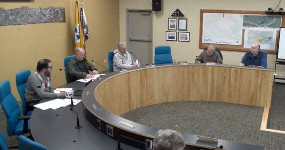 City Planner Ryan Foster (left) reads out a memorandum as a preview to the planning commission’s discussion on implementing a moratorium for specific conditional use permit applications on Wednesday, Dec. 4, 2024, in the Homer City Hall Cowles Council Chambers in Homer, Alaska. Screenshot.