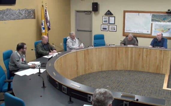 City Planner Ryan Foster (left) reads out a memorandum as a preview to the planning commission’s discussion on implementing a moratorium for specific conditional use permit applications on Wednesday, Dec. 4, 2024, in the Homer City Hall Cowles Council Chambers in Homer, Alaska. Screenshot.