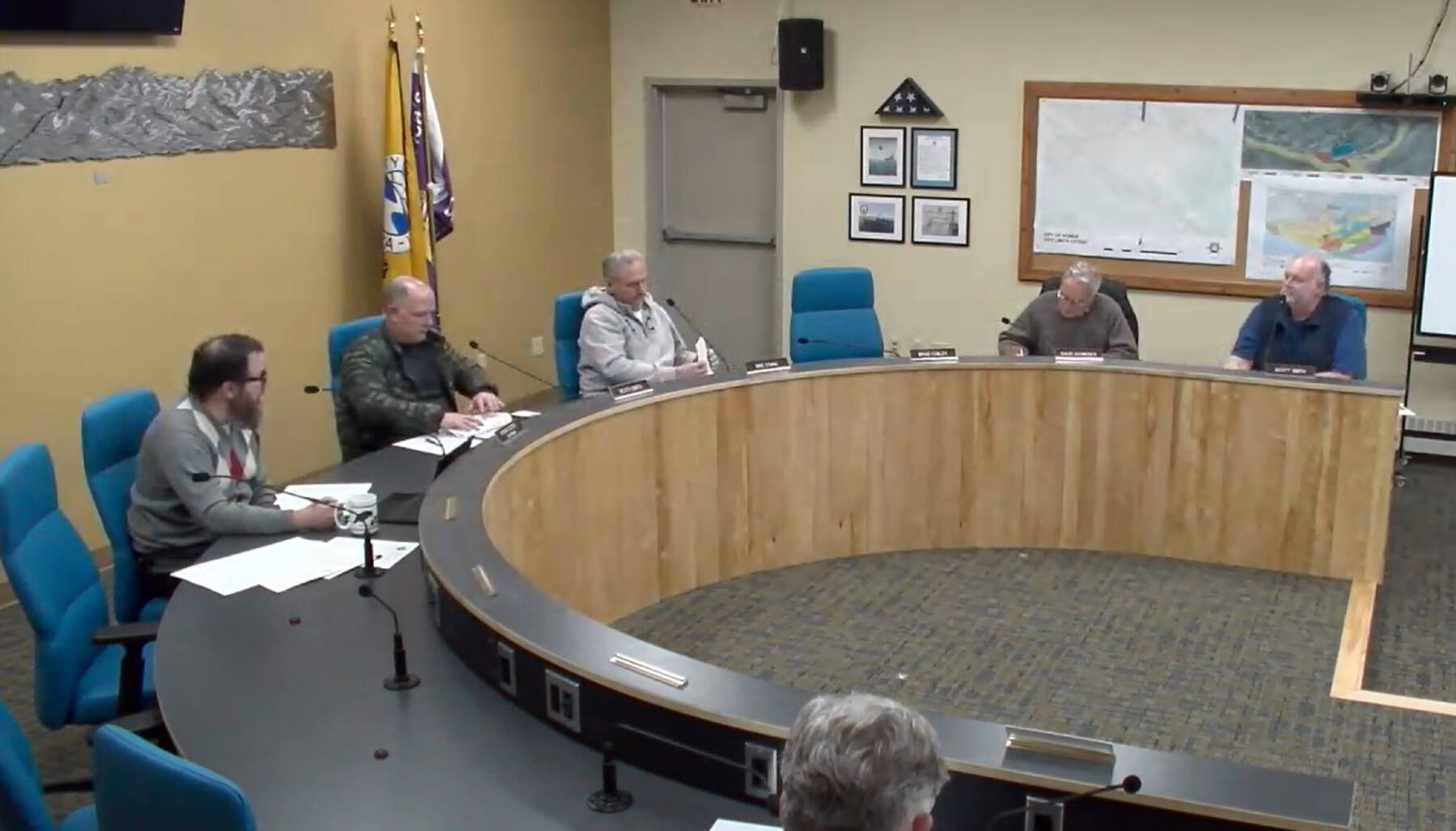 City Planner Ryan Foster (left) reads out a memorandum as a preview to the planning commission’s discussion on implementing a moratorium for specific conditional use permit applications on Wednesday, Dec. 4, 2024, in the Homer City Hall Cowles Council Chambers in Homer, Alaska. Screenshot.