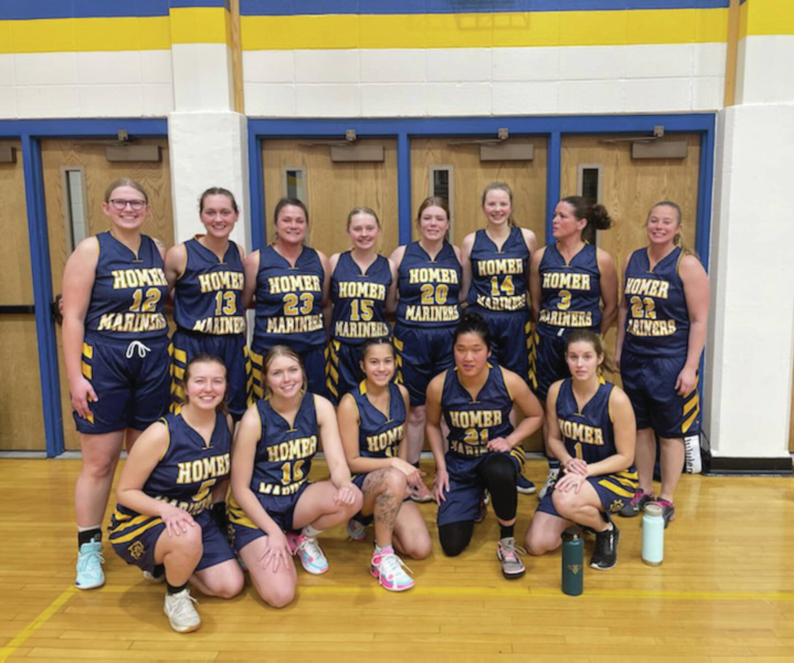 Homer Mariner 2024 alumni team poses in the Mariner gym before the start of the girls game on Saturday<ins>, Dec. 21, 2024,</ins> <ins>in Homer, Alaska</ins>. (Emilie Springer/ Homer News)