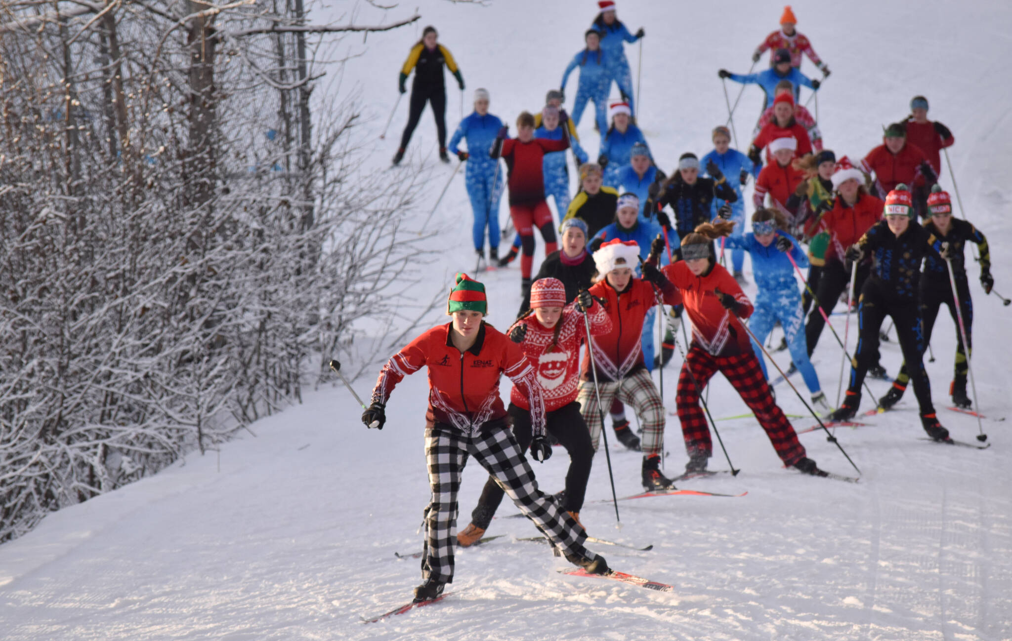 Kenai Central's Isla Crouse and Ruby Davis lead the pack at the Candy Cane Scramble on Friday, Dec. 20, 2024, at Tsalteshi Trails just outside of Soldotna, Alaska. (Photo by Jeff Helminiak/Peninsula Clarion)