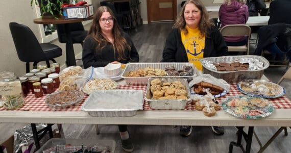 Laurie Rudy (right), board treasurer for the Anchor Point Food Pantry, and Rebecca Rudy (left) host the first night of a two-day bake sale fundraiser for the Anchor Point Food Pantry held at the Virl “Pa” Haga VFW Post 10221 on Friday, Dec. 20, 2024, in Anchor Point, Alaska. Items for sale during the fundraiser were made and donated by members of the community. (Delcenia Cosman/Homer News)