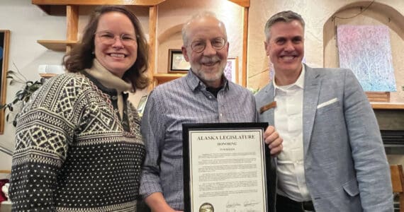 Alaska Representatives Sarah Vance from Homer and Andrew Gray from Anchorage present Tom Kizzia with a state legislative citation award at the Homer Public Library on Tuesday, Dec. 17.  Photo provided by Cheryl Illg with Friends of the Homer Public Library.