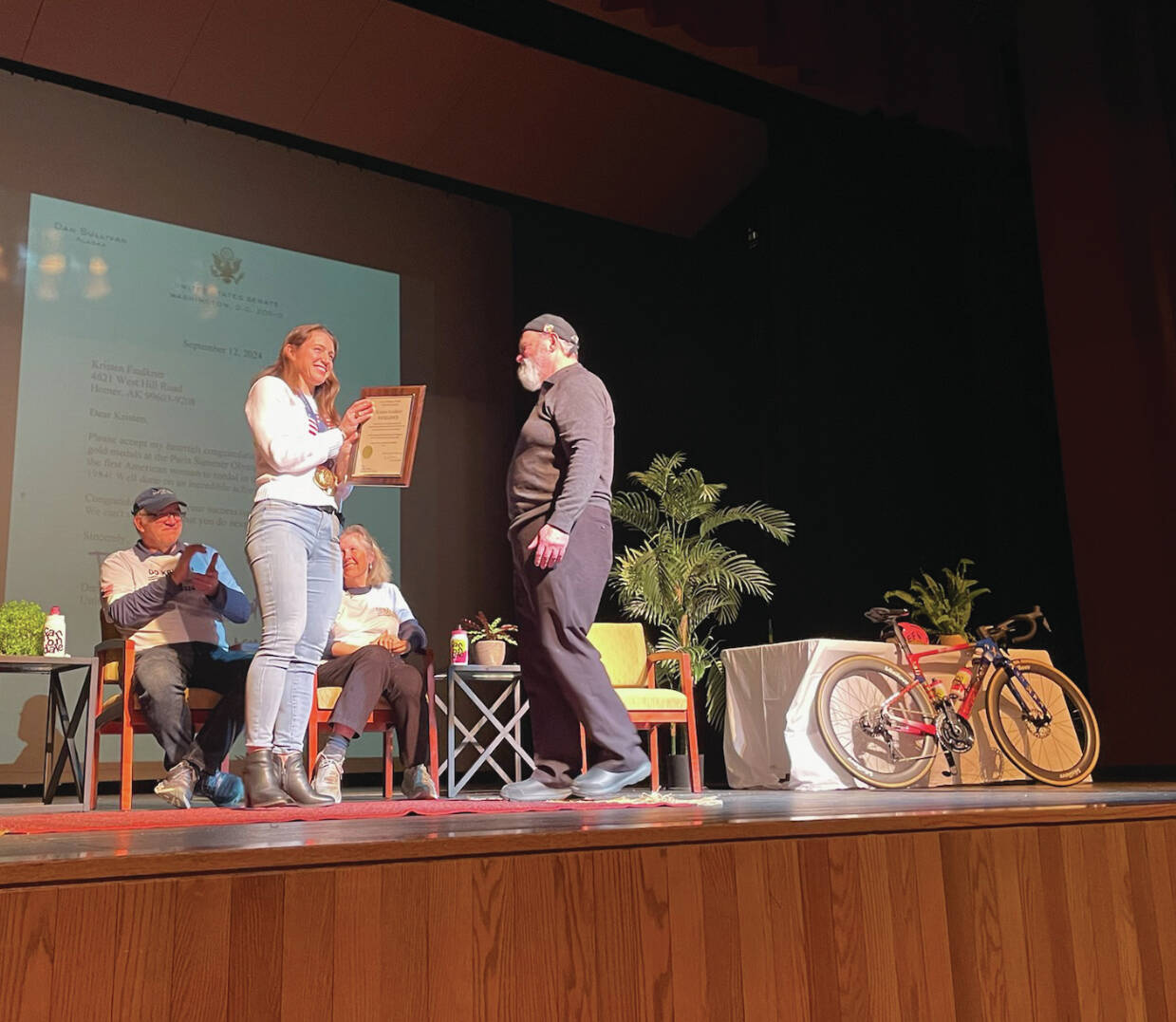 Emilie Springer/ Homer News
Ken Castner presents Kristen Faulkner with a City of Homer award of excellence at a reception ceremony at the Homer Mariner Theater in Homer, Alaska on Dec. 27, 2024, in Homer, Alaska.