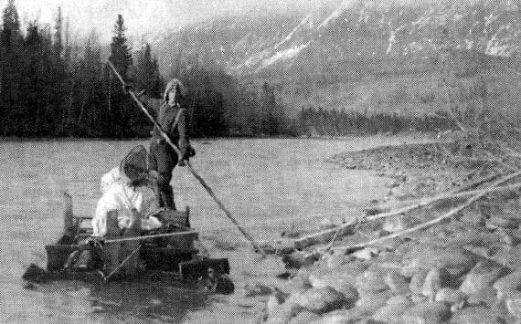 Keith McCullagh is photographed poling a raft down the Kenai River in 1911 during a forest survey. (U.S. Forestry Department photo by John “Jack” Brown)