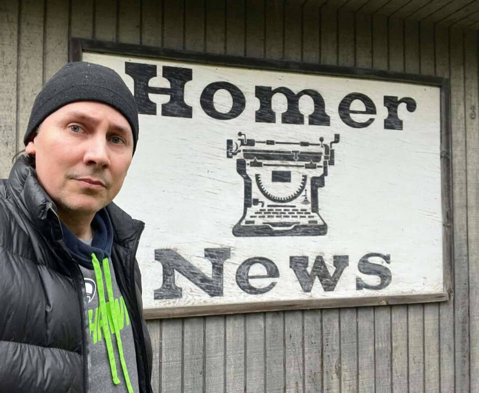 Tim Hatfield takes a selfie with the Homer News sign, displayed on the side of the paper’s old office on Landings Street, on Nov. 17, 2024, in Homer, Alaska. Photo provided by Tim Hatfield