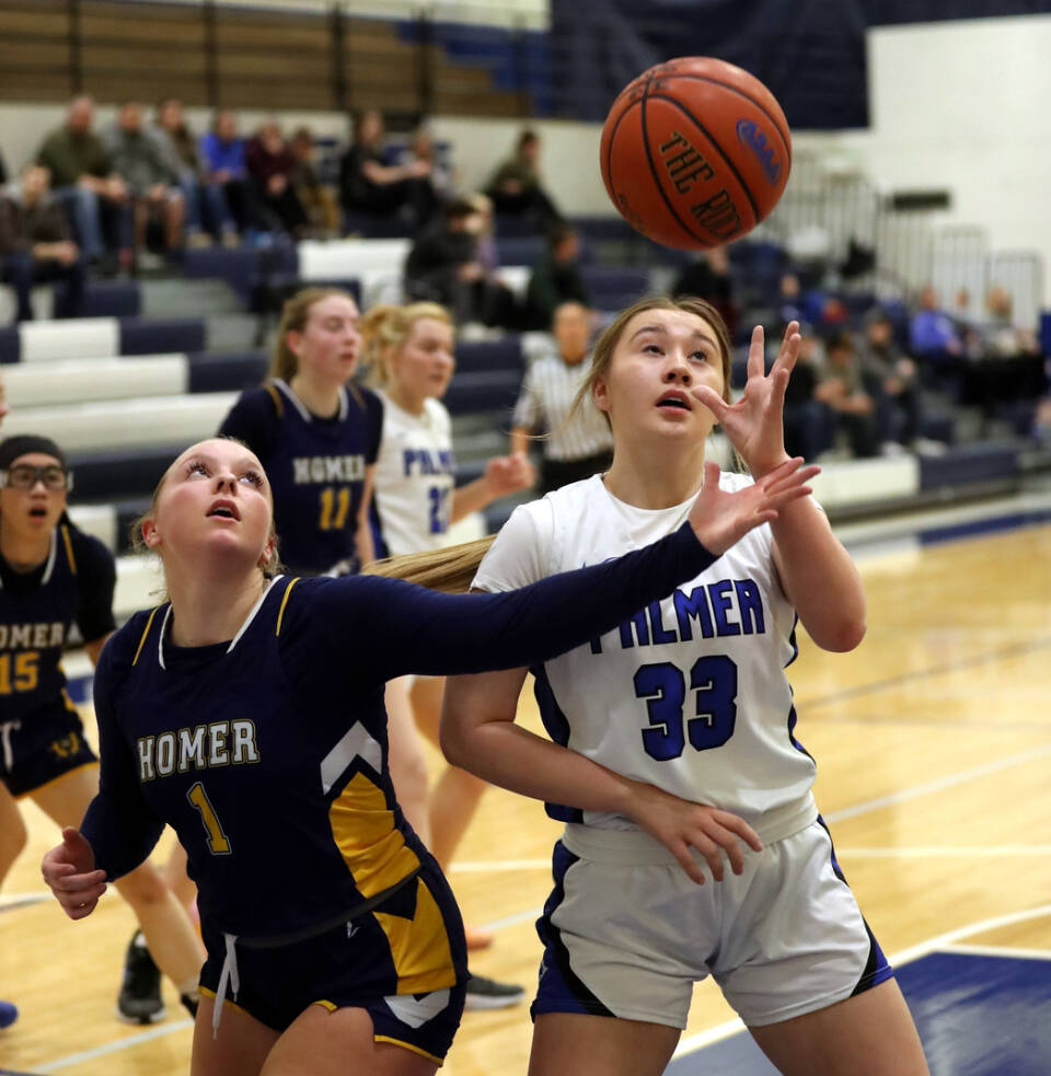 Homer’s Channing Lowney tries to knock the ball away from Palmer’s Kaelyn Downey during a loss to the Moose on Friday, Jan. 10, 2025, the second day of the Palmer Elks Showdown at Palmer High School. Photo courtesy of Bruce Eggleston