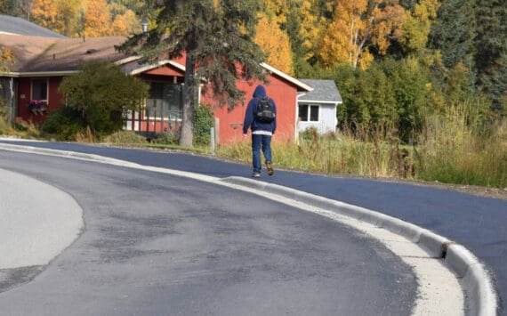 A local community member walks up Ben Walters Lane on a newly completed sidewalk on Monday, Sept. 30, 2024, in Homer, Alaska. The City of Homer was recently awarded a federal grant for the city’s continued efforts in establishing nonmotorized transportation access. (Delcenia Cosman/Homer News file)