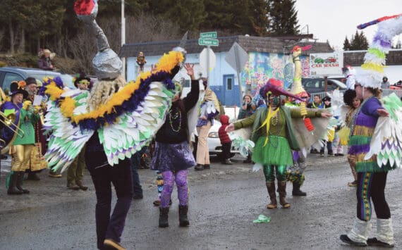 Members of the Krewe of Gambrinus, costumed as sandhill cranes, dance in front of the judges and crowd gathered at the 70th annual Homer Winter Carnival Parade on Pioneer Avenue on Saturday, Feb. 10, 2024, in Homer, Alaska. (Delcenia Cosman/Homer News)