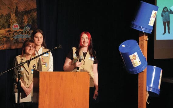 Girl Scout Troop 210, which includes Caitlyn Eskelin, Emma Hindman, Kadie Newkirk and Lyberty Stockman, present their "Bucket Trees" to a panel of judges in the 34th Annual Caring for the Kenai Competition at Kenai Central High School in Kenai, Alaska, on Thursday, April 18, 2024. (Jake Dye/Peninsula Clarion)