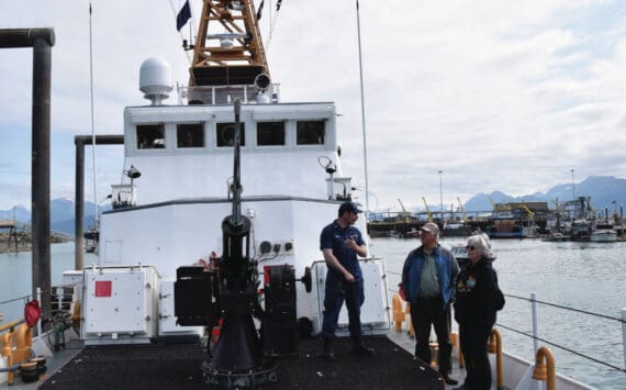 U.S. Coast Guard officer Alexander Curran shows Homer visitors the bow of the USCG cutter Naushon on Aug. 4, 2023, in Homer, Alaska. (Emilie Springer/ Homer News.)